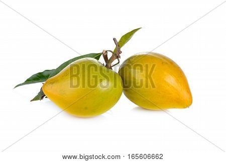 ripe Tiesa or egg fruit with stem and leaves on white background