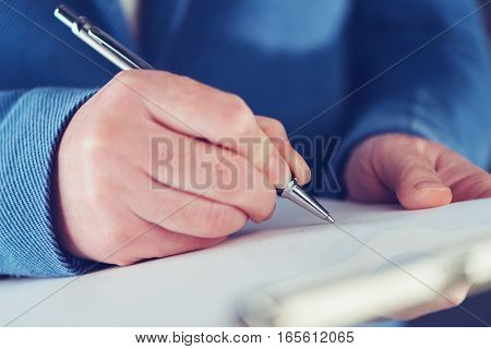 Businesswoman signing business contract agreement close up of female hand with pencil writing signature