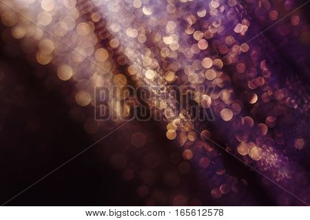 Glitter and glow soft multi colored bokeh shining . Dark abstract dreamy wonderful sparkle background.