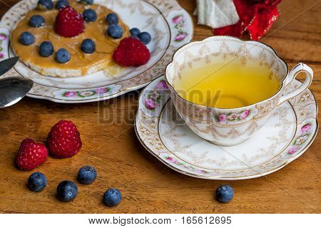 Cup Of Tea, Sauser, Rice Cracker With Peanut Butter, Berries And Honey On The Wooden Table