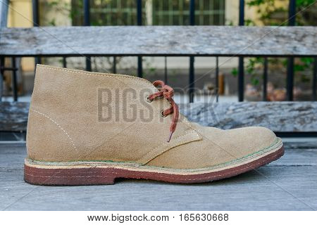 Deerskin shoe is on the wooden chair