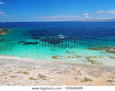 View from the beach of a boat on the sea