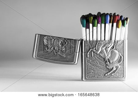 Colorful matchsticks in a lighter case isolated