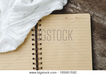 Blank notebook with lace on wooden background