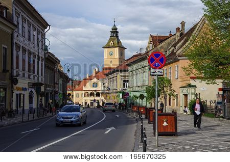 Brasov, Romania - April 29, 2014: Street of old town with town hall building on Council Square at background.