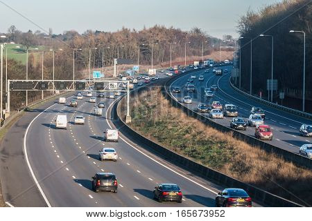 London, UK - January 18, 2017: Busiest British motorway M25 with cars and lorries in a winter sunset time.