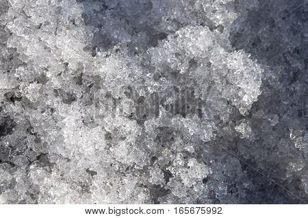 Snow with ice like a glass and crystal in early spring