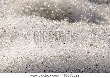 Snow with ice like a glass and crystal in early spring