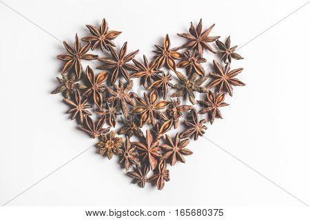 Star anise spice in the form of heart, isolated on a white background closeup
