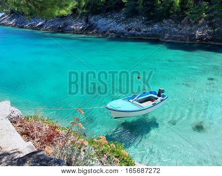 Boat on the bright, clear, blue sea