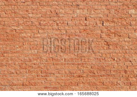 wall made of red stone blocks - The color of the Italian stone has a marble looking surface and its color naturally resembles bricks.