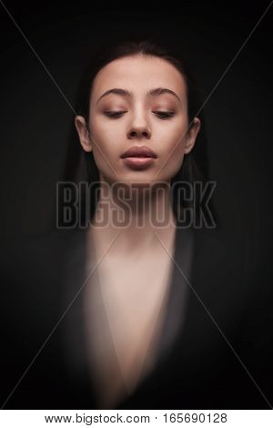 portrait young elegant woman with closed eyes wearind black jacket. Fashion studio shot. Motion effect