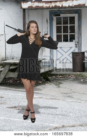 Beautiful young woman with an automatic rifle