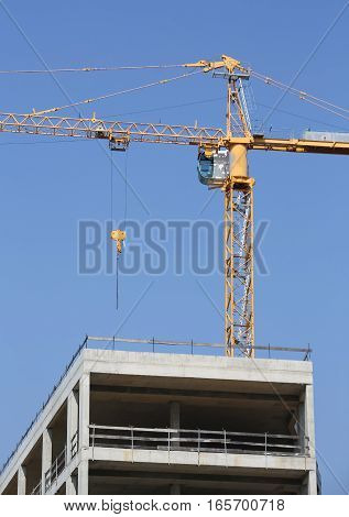 Building Under Construction  And A Yellow Crane