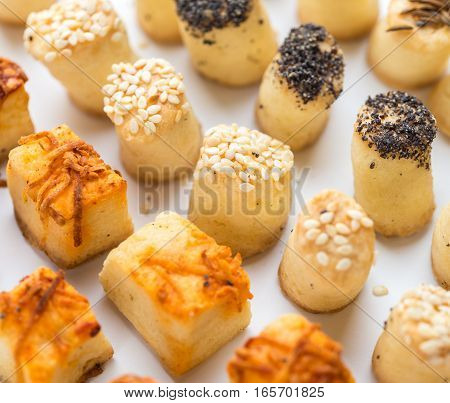 Salty party snacks stands in a row. Closeup details.