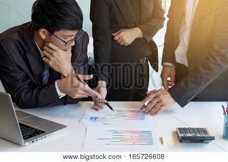 Teamwork process. young business managers crew working with new startup project. labtop on office wood table typing keyboard texting message analyze graph plans