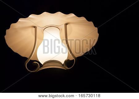 Beautiful street lamp shining on black background