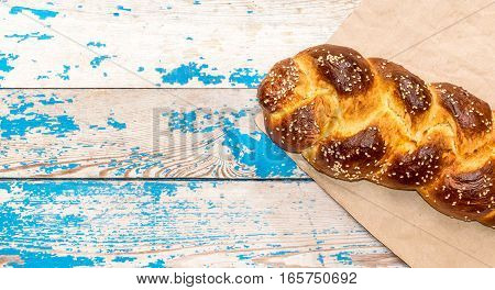 Sweet bun on old blue wooden background.