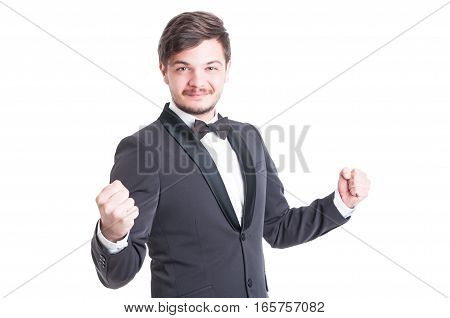 Handsome Man Wearing Tuxedo And Bowtie Making Success Gesture