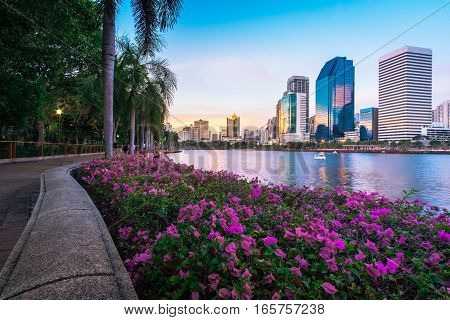 Cityscape photography of Benchakitti Park at twilight time in Bangkok, Thailand. Outdoor evening landscape of modern city skyscrapers in Asia