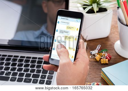 Close-up Of A Person Sending Text Message On Mobile Phone