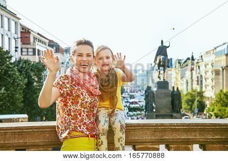 Happy Mother And Daughter Tourists Handwaving In Prague