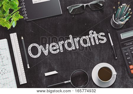Overdrafts on Black Chalkboard-Table. Office Composition. 3d Rendering. Toned Image.