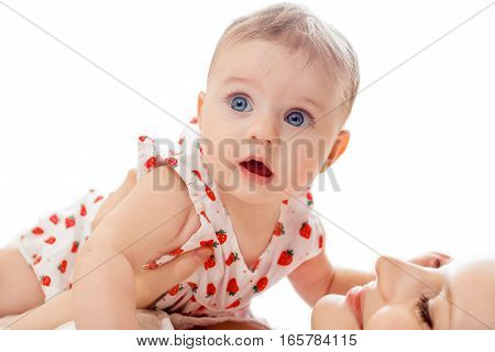 Portrait of mother and baby playing and smiling at home.