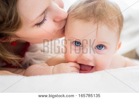 Portrait of mother and baby playing and smiling at home.
