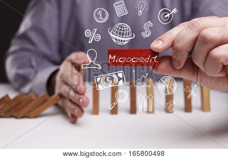 Business, Technology, Internet And Network Concept. Young Businessman Shows The Word: Microcredit