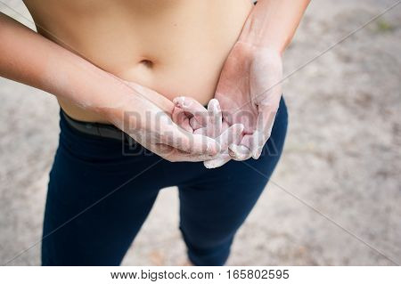 Woman's Hands With Magnesium Preparing Climbing