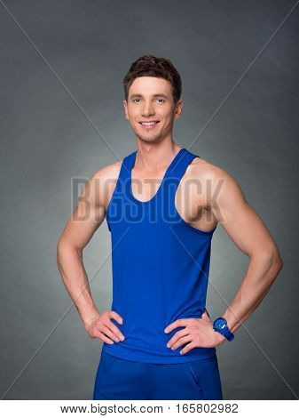 Handsome man on black background, blue t-shirt