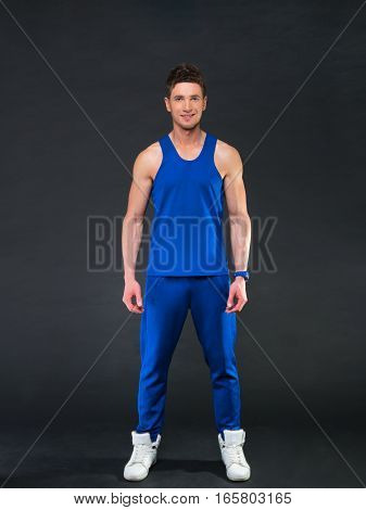Handsome man on black background, blue t-shirt