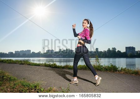 Woman Runner Outside In City Park On Sunny Day