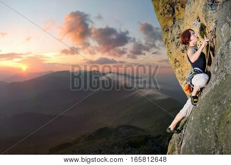 Female Climber Climbing With Rope On A Rocky Wall