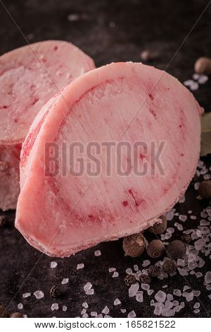 Detail Of Two Slices Of Marrowbone On Black Tray