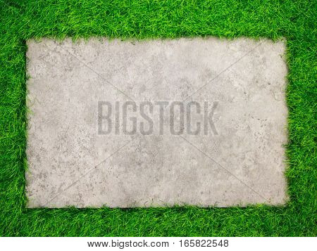 Square concrete plate on artificial green grass background