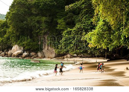 Afternoon on beach, Pulau Pangkor, Malaysia, children playing - July 2015