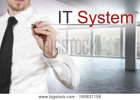businessman in modern empty office writing it system in the air