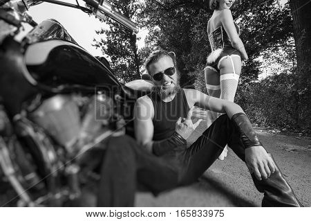 Portrait Of Brutal Biker And Beautiful Sexy Woman On Motorcycle