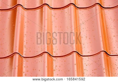 Fagment of red metal roof with many water drops as background closeup