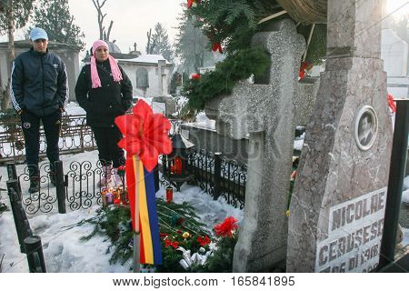 Bucharest Romania December 25 2009: People are praying at the grave of Romania's late communist dictator Nicolae Ceausescu during commemoration of his death. Year after year Romania's nostalgic Communists gather to mourn Ceausescu who was executed on Chri