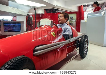 Bucharest Romania December 5 2009: A child is playing in a car at the opening of the Ferrari showroom in Bucharest.
