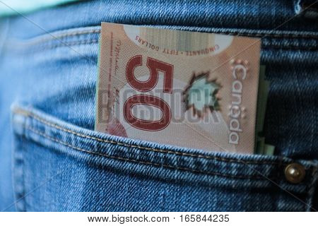 Bucharest Romania December 2 2015: Canadian currency in a blue jeans pocket.