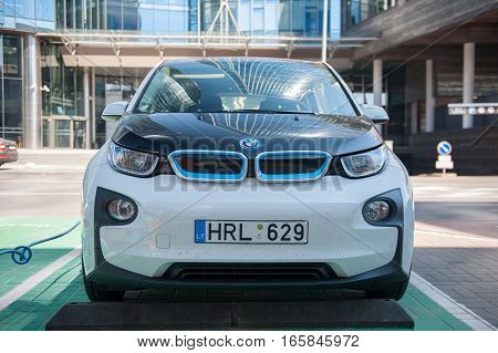 VILNIUS, LITHUANIA - AUG 6, 2015: Electric car BMW I3 charging its batteries. The BMW i3, previously Mega City Vehicle (MCV), is a five-door urban electric car developed by the German manufacturer BMW