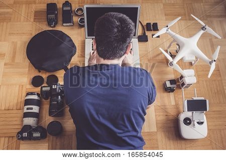 Photographer with lots of equipment planning his next shoot