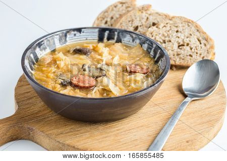 Christmas cabbage soup with mushrooms on cutting board..