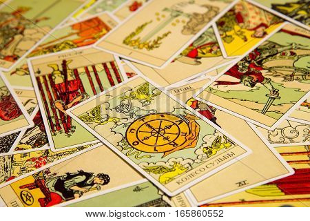 Moscow, Russia - December 4, 2016: Tarot card Wheel of Fortune with other cards. Rider-Waite tarot deck. Esoteric background