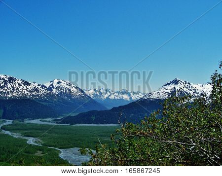 Majestic mountain view on a calm spring or summer day. Beautiful Alaska landscape with spring runoff from the mountains.