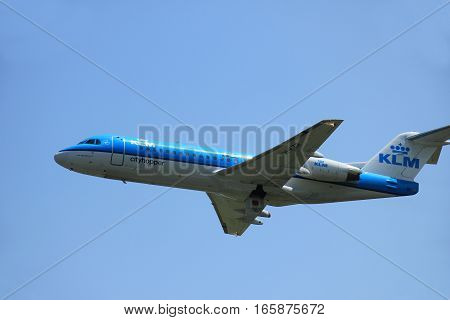 Amsterdam The Netherlands - June 12 2015: PH-KZR KLM Cityhopper Fokker F70 takes off at Amsterdam Airport Schiphol Polderbaan runway.